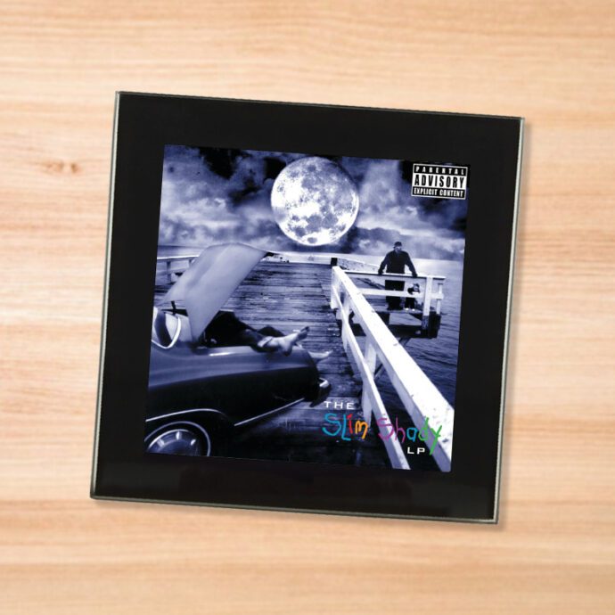 Black glass Eminem - Slim SHady LP coaster on a wood table
