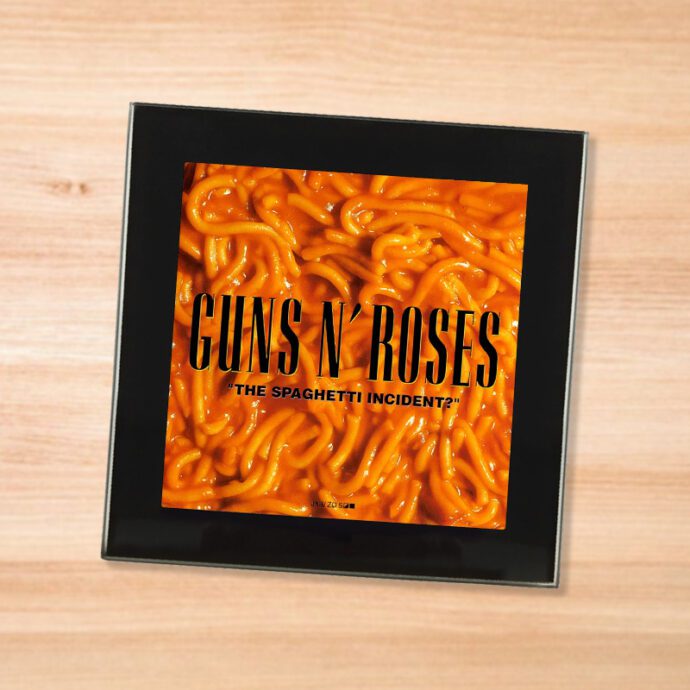 Black glass Guns N Roses - Spaghetti Incident coaster on a wood table