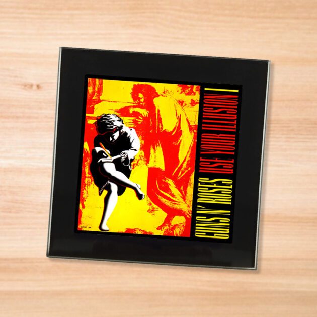 Black glass Guns N Roses - Use Your Illusion 1 coaster on a wood table