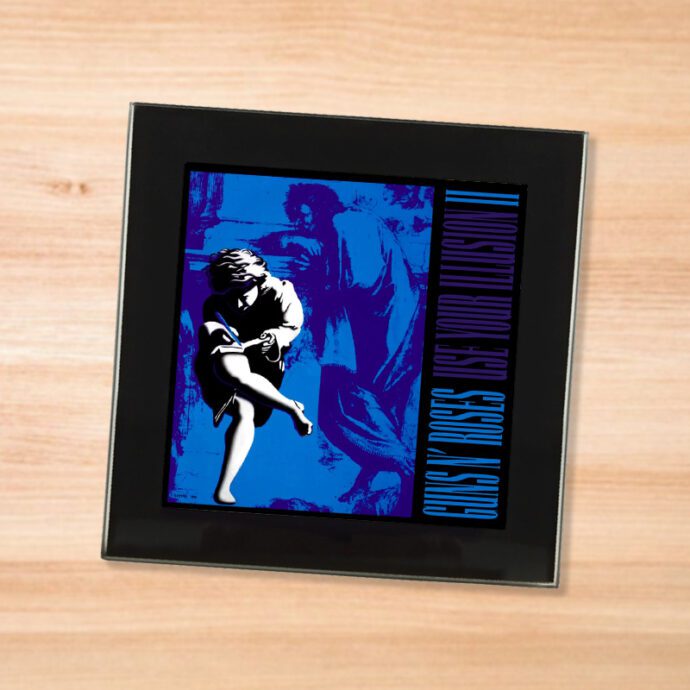 Black glass Guns N Roses - Use Your Illusion 2 coaster on a wood table