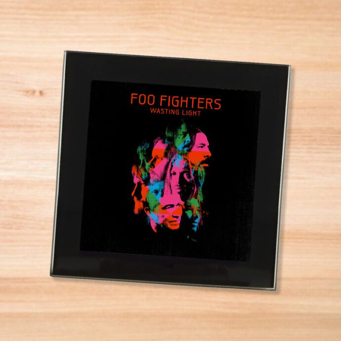 Black glass Foo Fighters - Wasting Light coaster on a wood table
