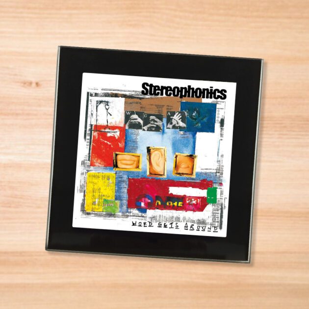 Black glass Stereophonics - Word Gets Around coaster on a wood table