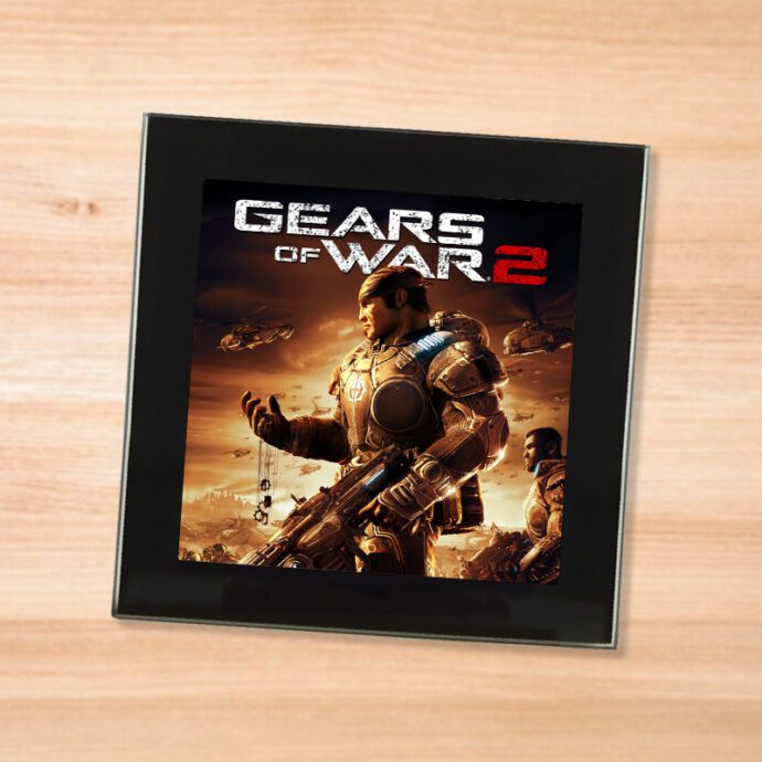 Black glass Gears of War 2 coaster on a wood table