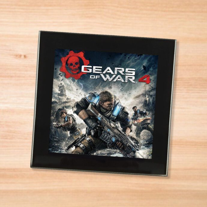 Black glass Gears of War 4 coaster on a wood table