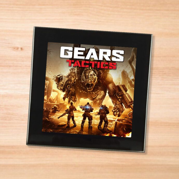 Black glass Gears Tactics coaster on a wood table