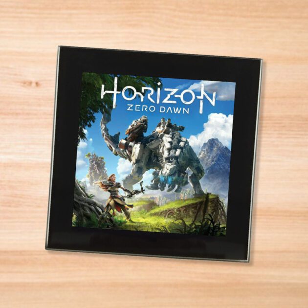 Black glass Horizon Zero Dawn coaster on a wood table