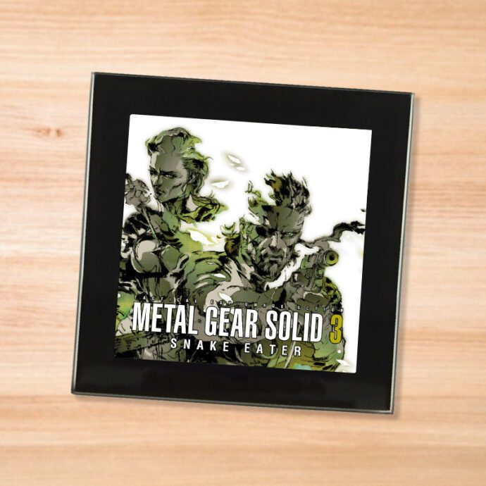 Black glass Metal Gear Solid 3 coaster on a wood table