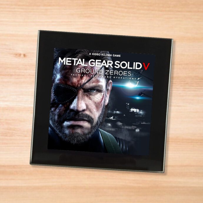 Black glass Metal Gear Solid 5 Ground Zeroes coaster on a wood table