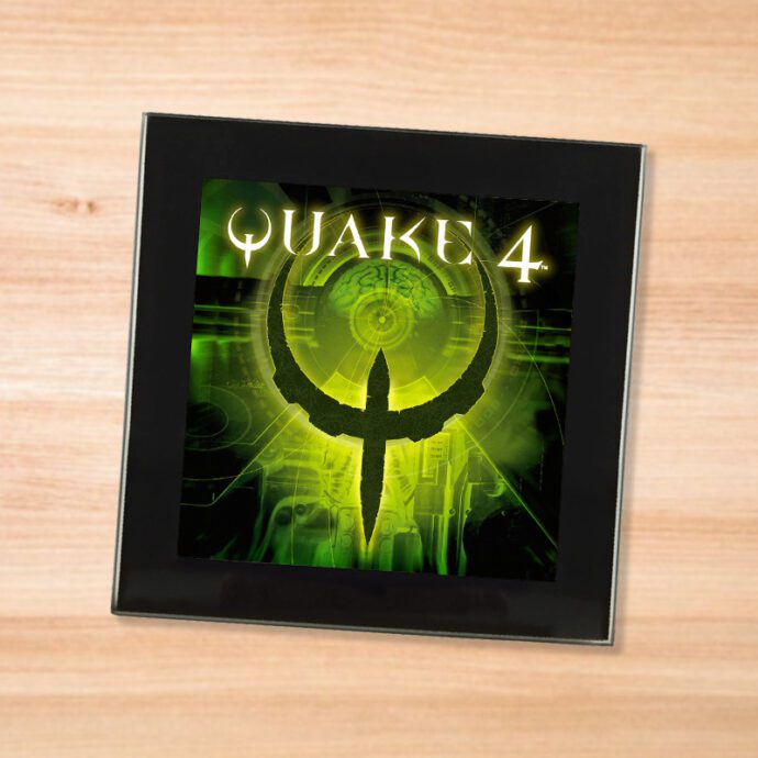 Black glass Quake 4 coaster on a wood table