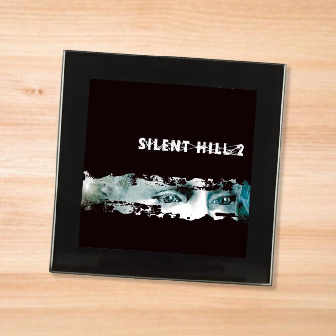 Black glass Silent Hill 2 coaster on a wood table