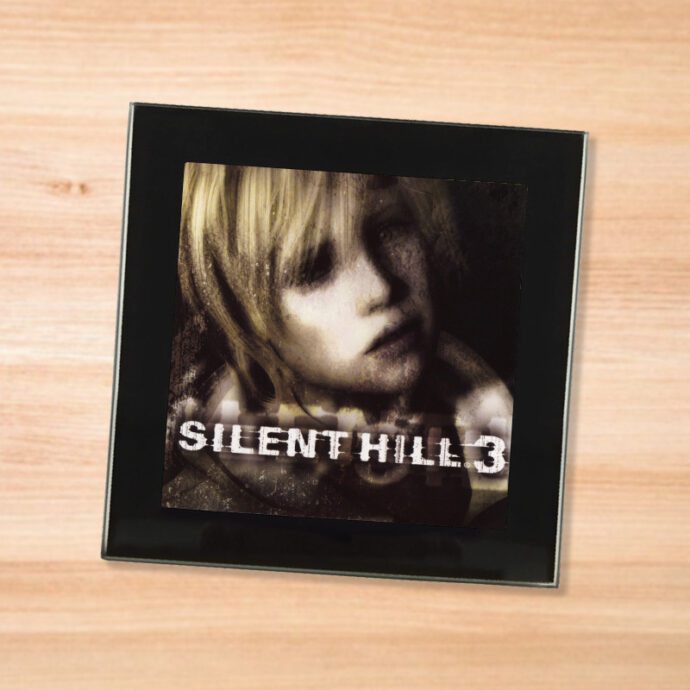 Black glass Silent Hill 3 coaster on a wood table