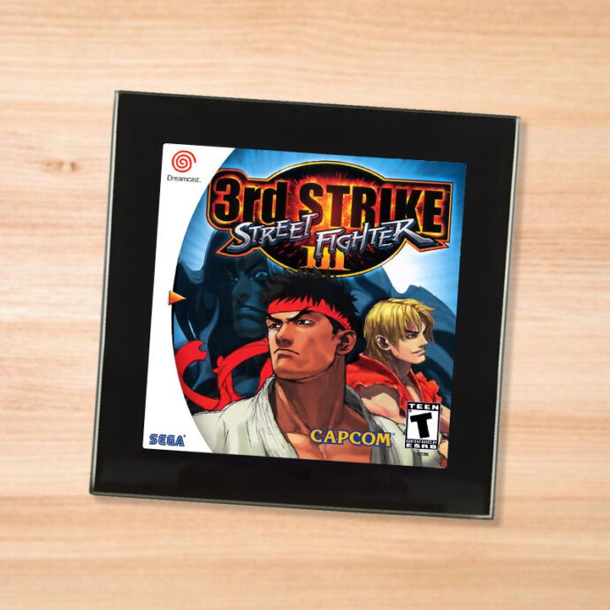 Black glass Street Fighter 3 coaster on a wood table