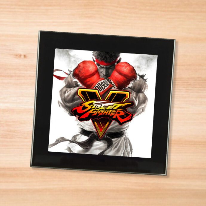 Black glass Street Fighter 5 coaster on a wood table