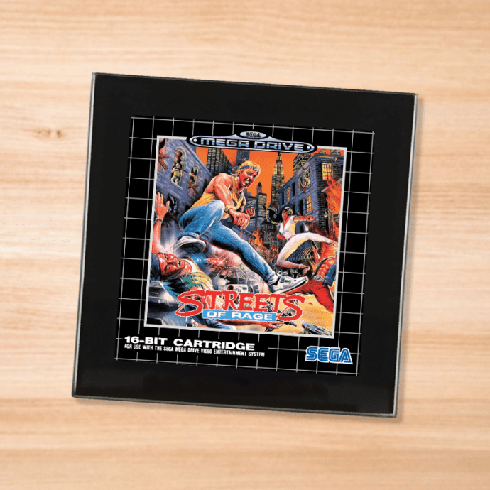 Black glass Streets of Rage coaster on a wood table