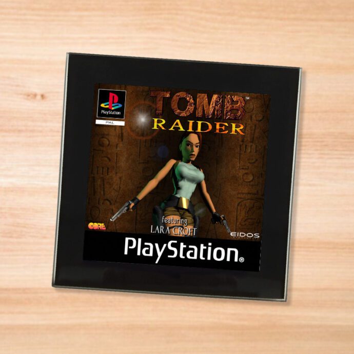 Black glass Tomb Raider coaster on a wood table