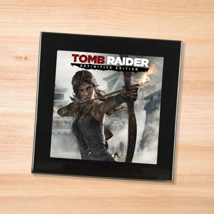 Black glass Tomb Raider coaster on a wood table