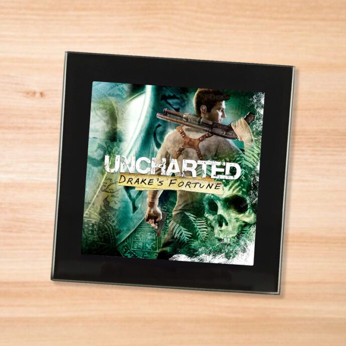 Black glass Uncharted coaster on a wood table