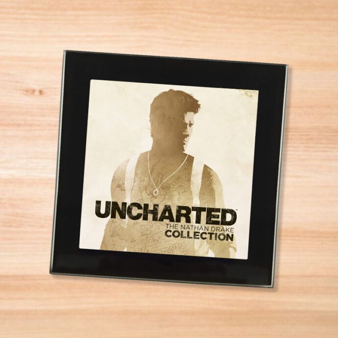 Black glass Uncharted Collection coaster on a wood table