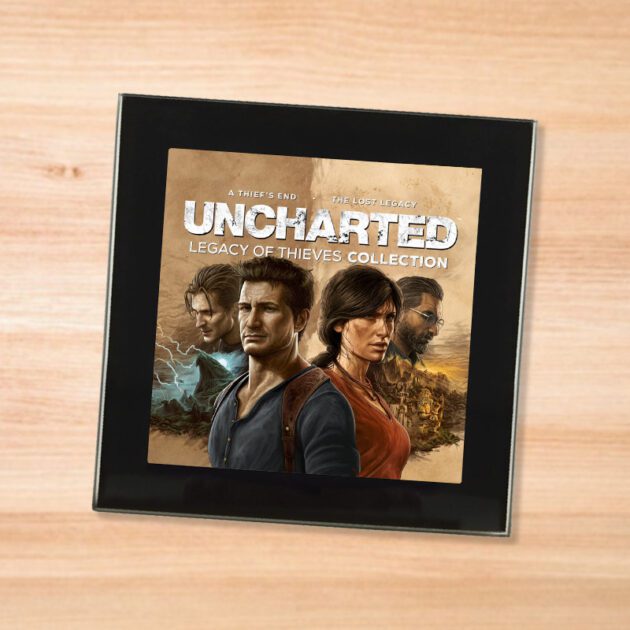 Black glass Uncharted Legacy of Thieves coaster on a wood table