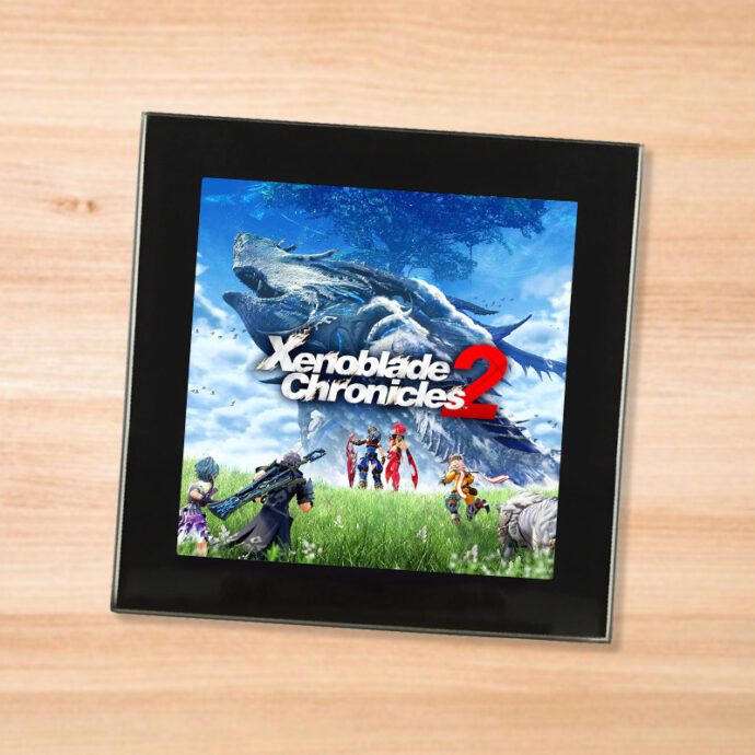 Black glass Xenoblade Chronicles 2 coaster on a wood table