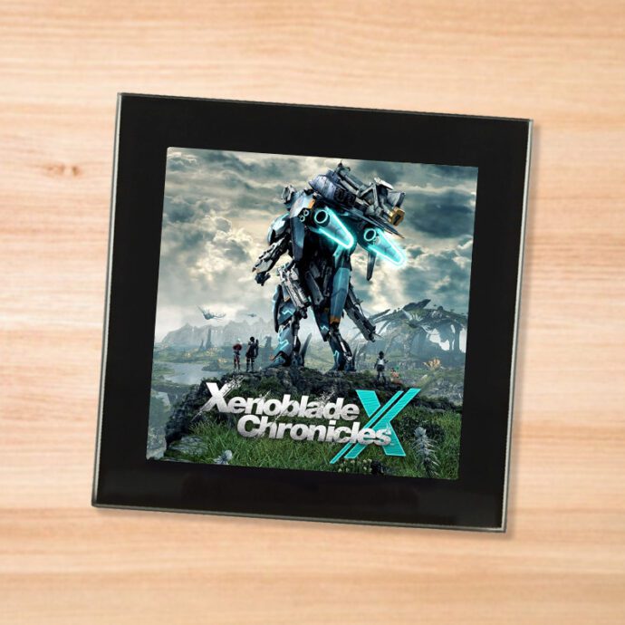 Black glass Xenoblade Chronicles X coaster on a wood table