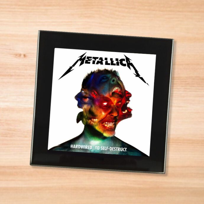 Black glass Metallica - Hardwired to Self Destruct coaster on a wood table