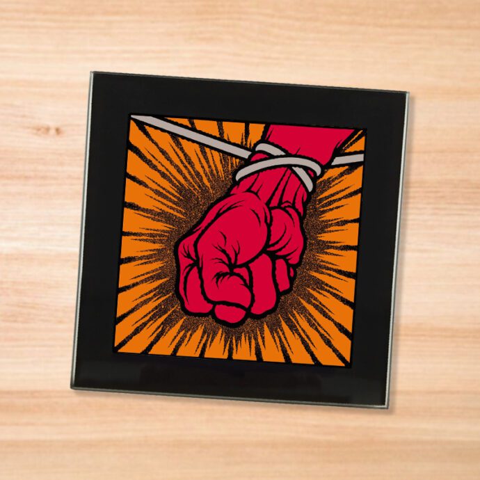 Black glass Metallica - St Anger coaster on a wood table