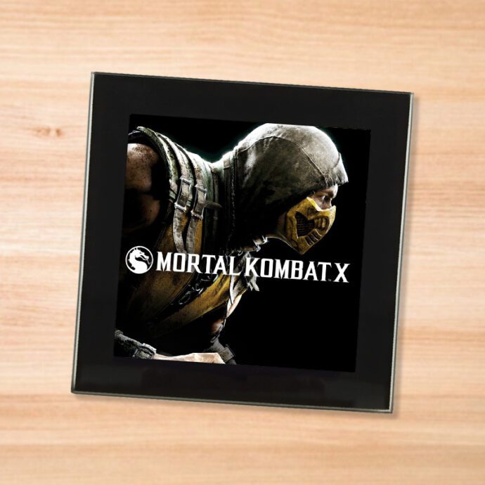 Black glass Mortal Kombat X coaster on a wood table