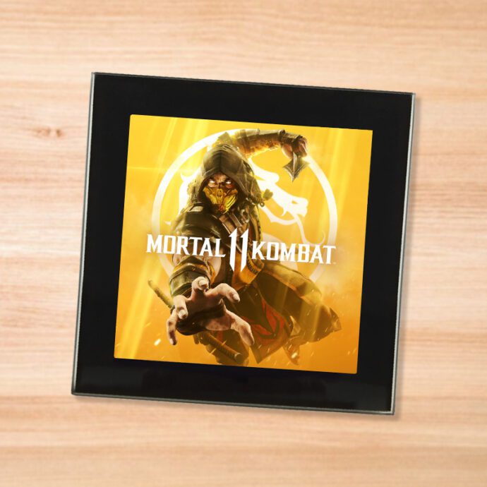 Black glass Mortal Kombat 11 coaster on a wood table