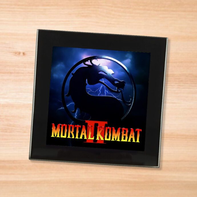 Black glass Mortal Kombat 2 coaster on a wood table