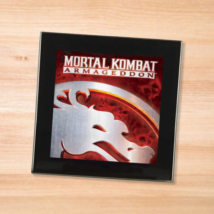 Black glass Mortal Kombat Armageddon coaster on a wood table