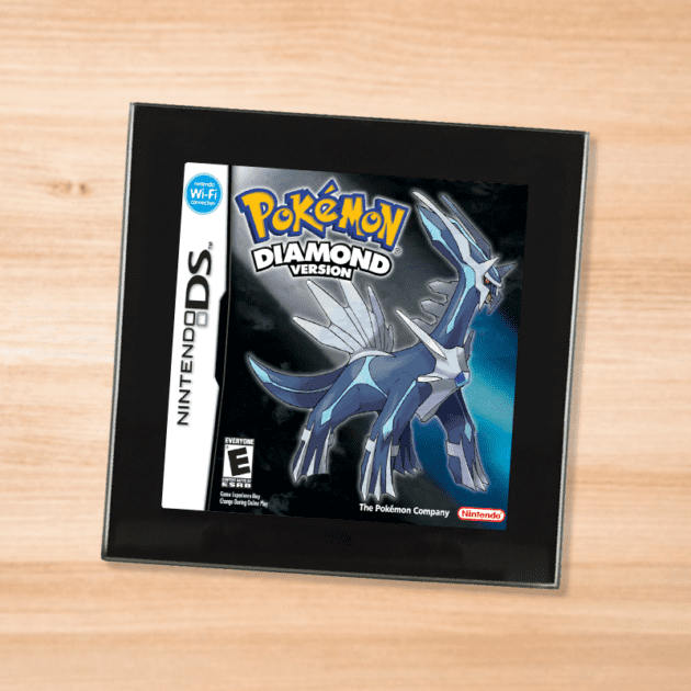 Pokemon Diamond black glass coaster on a wood table
