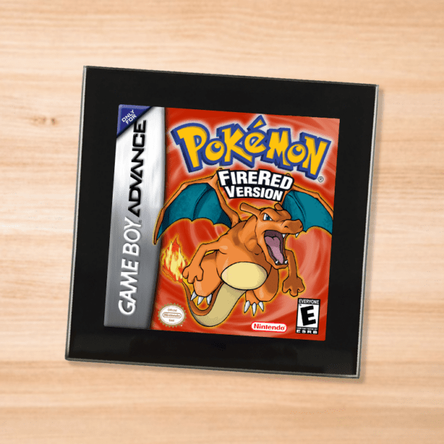 Pokemon Fire Red black glass coaster on a wood table
