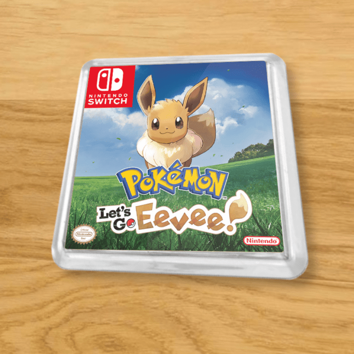 Pokemon Let's Go Eevee plastic coaster on a wood table