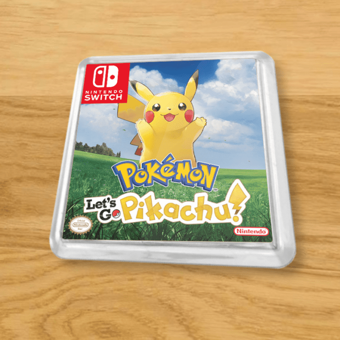 Pokemon Let's Go Pikachu plastic coaster on a wood table
