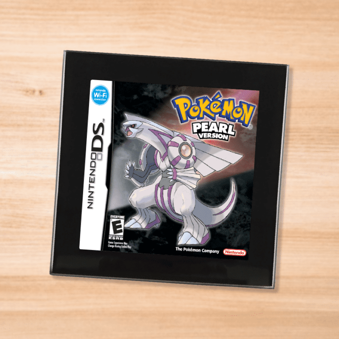 Pokemon Pearl black glass coaster on a wood table