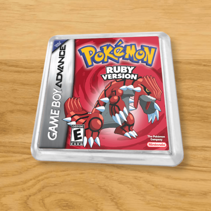 Pokemon Ruby plastic coaster on a wood table