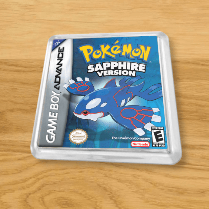 Pokemon Sapphire plastic coaster on a wood table