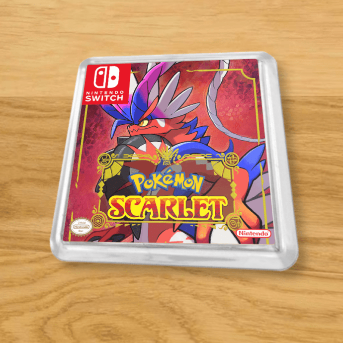Pokemon Scarlet plastic coaster on a wood table