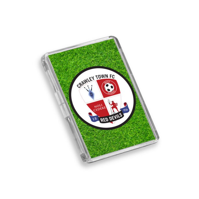 Plastic Crawley Town fridge magnet on a white background