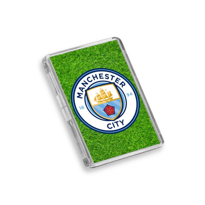 Plastic Manchester City fridge magnet on a white background