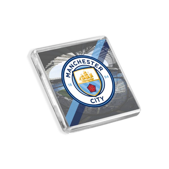 Plastic Manchester City fridge magnet on a white background